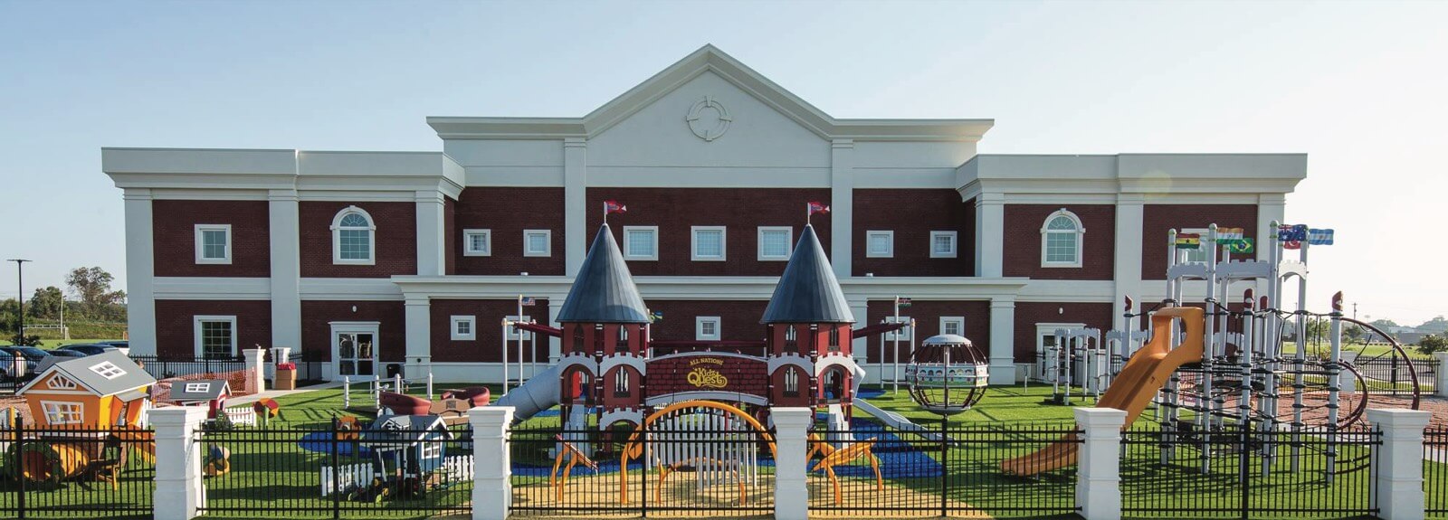 The ACA Daycare building with its fenced outdoor playground