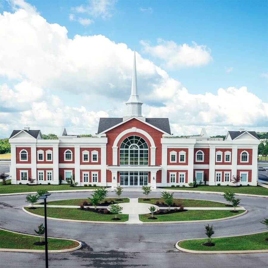 Front of the Apostolic Christian Academy building with its white steeple